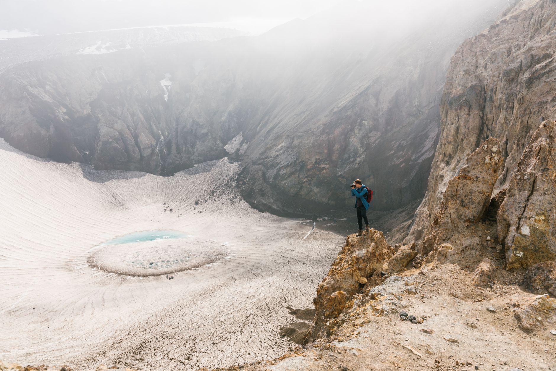Travel journal photographer taking photos on a cliff